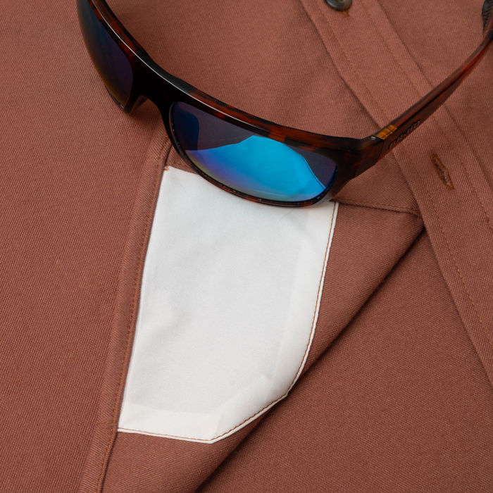 sunglasses with lens cleaner on shirt