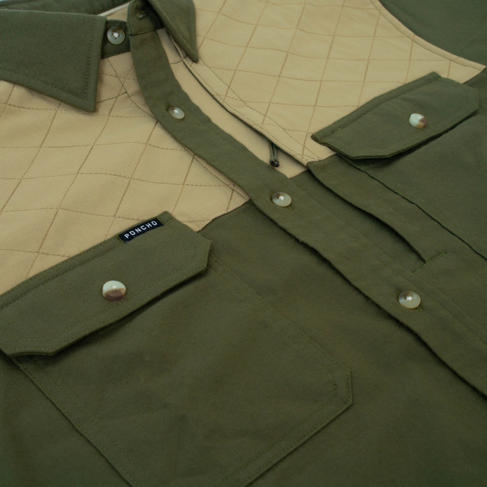 Close-up of olive green and tan quilted outdoor shirt called The Roosevelt with buttoned pockets
