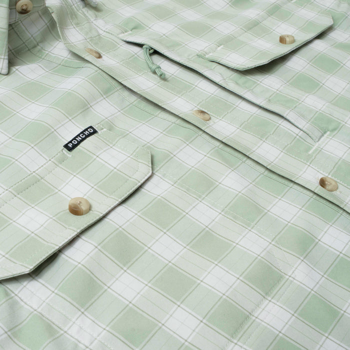 Close-up of The Sapelo outdoor shirt in light green plaid with buttoned pockets and Poncho label