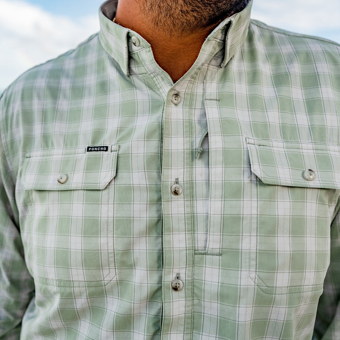 Close-up of green plaid button-up "The Sapelo" outdoor shirt with chest pockets and Poncho label