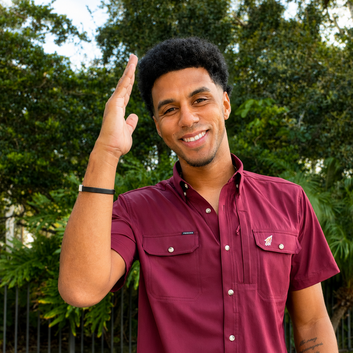 Smiling man outdoors wearing a maroon short-sleeve button-up shirt called The Seminole.