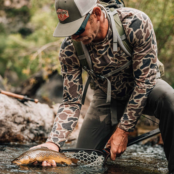 man with fish wearing camo hoodie