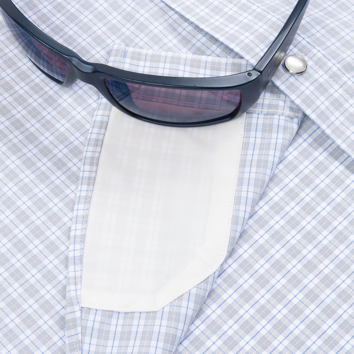 Closeup of sunglasses with lens cleaner on shirt