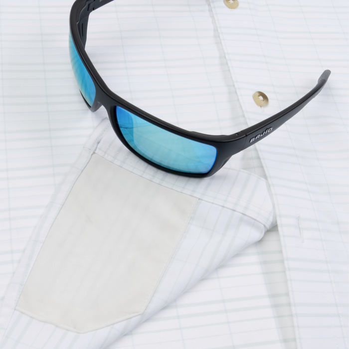 sunglasses with lens cleaner on shirt