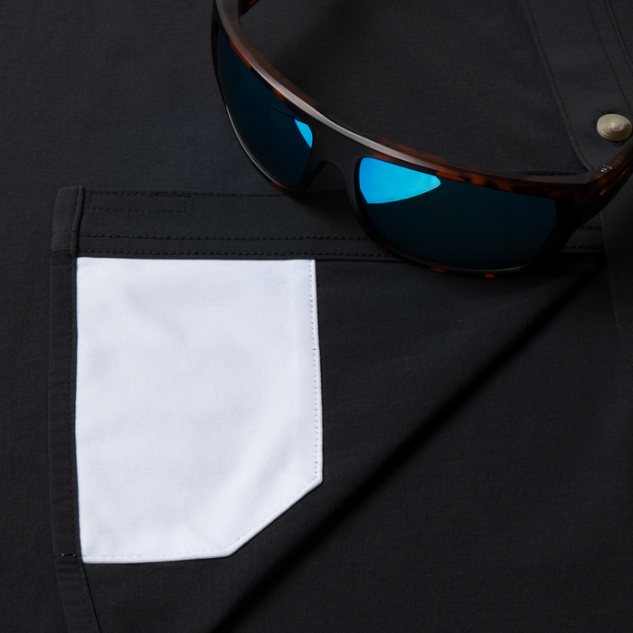 sunglasses with lens cleaner on shirt