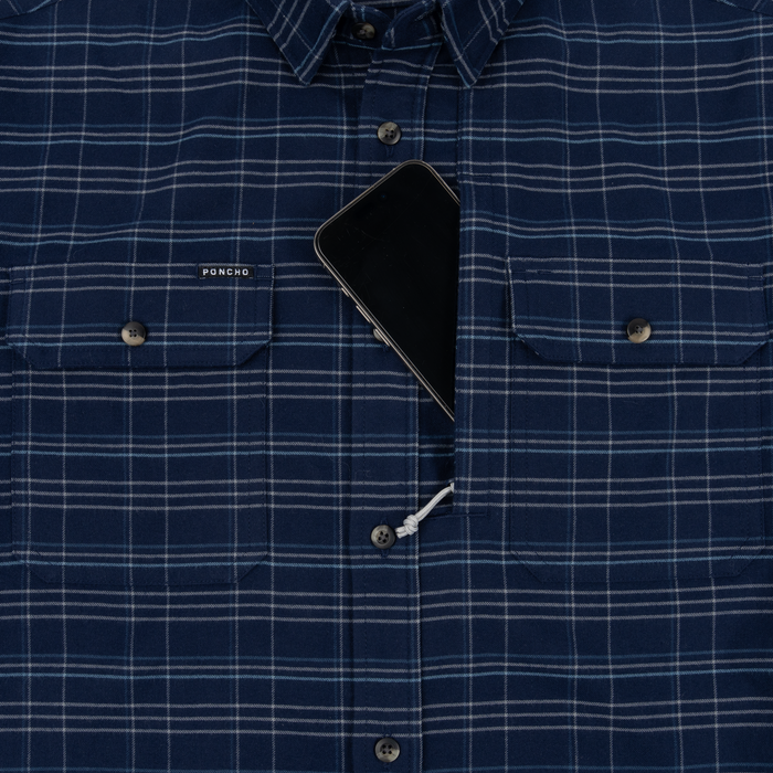 The Sturgeon blue plaid shirt with button pockets and a phone in the center opening