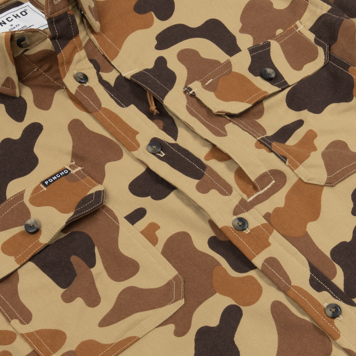 Close-up of The Stuttgart shirt showcasing a brown and tan camouflage pattern with buttoned chest pockets and sturdy stitching.