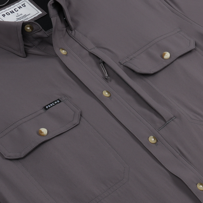 Close-up of The Tripletail shirt showing purple fabric with buttoned chest pockets and zipper detail