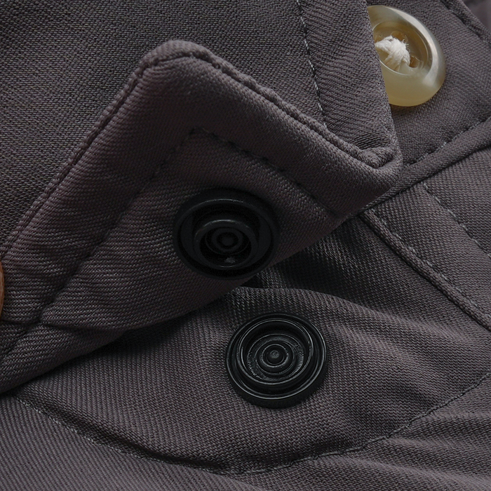 Close-up of durable button and snap fastener details on The Tripletail shirt in dark fabric