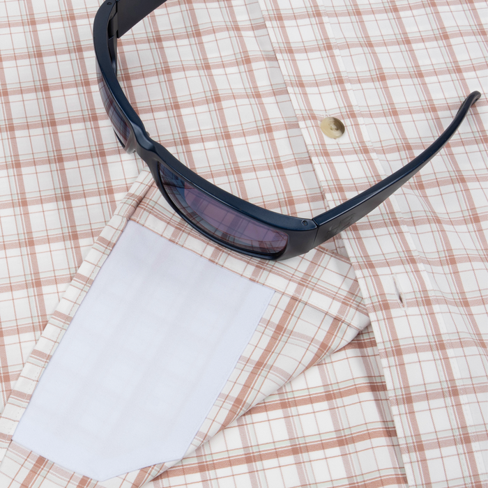 Closeup of sunglasses with lens cleaner on shirt