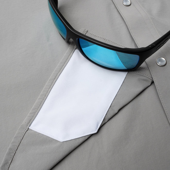 Closeup of sunglasses with lens cleaner on shirt