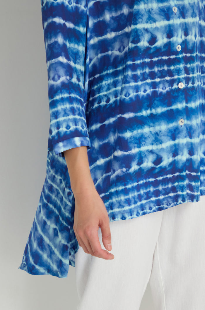 Model wears the Tie Dye Printed Viscose Shirt in blue and white with white pants, shown from shoulder to mid-thigh against a plain background.