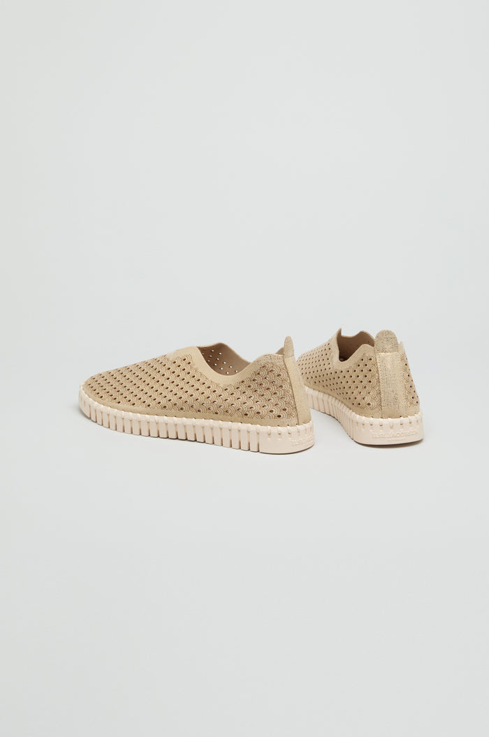 A pair of beige Tulip Glitter Slip on Shoes by Ilse Jacobsen, featuring perforations and textured soles, displayed on a plain white background.