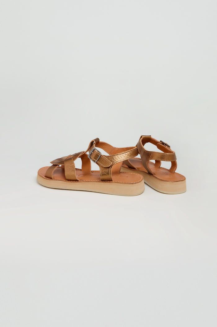 A pair of Tulum Leather Sandals in brown, featuring strappy buckle closures, open toes, and flat beige soles, displayed on a plain white background.